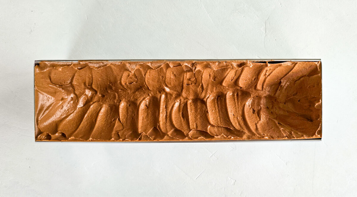 Chocolate mousse poured into the Yule log mold, ready for the pear caramel inserts.