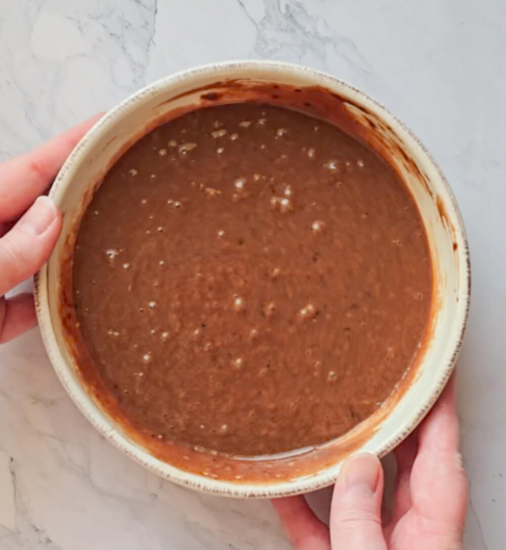 Un bol rempli d'une préparation pour mugcake chocolat noisette avant cuisson.