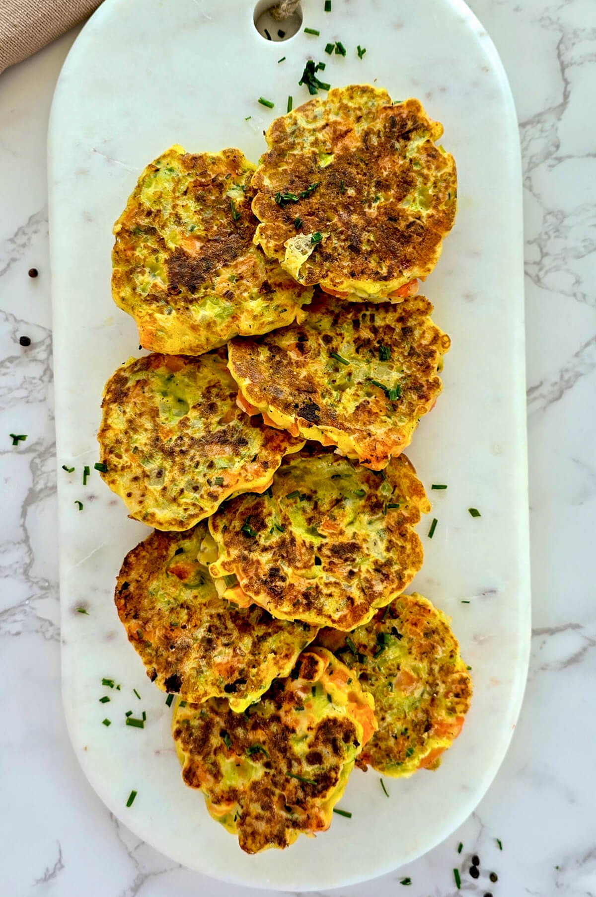 Des palets de légumes sur une planche marbré blanche.