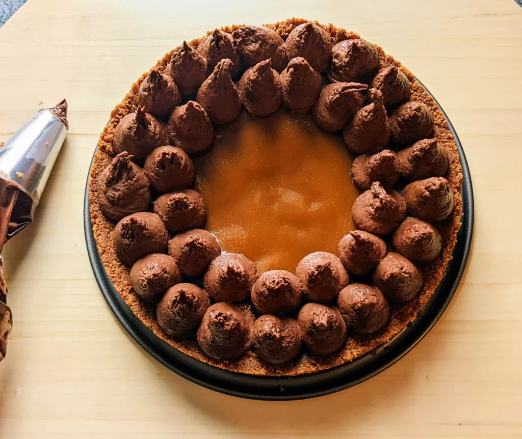 Tarte chocolat spéculoos avec une poche à douille